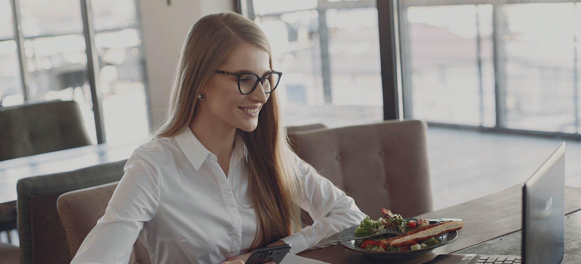Smiling woman on a virtual call with a lunch