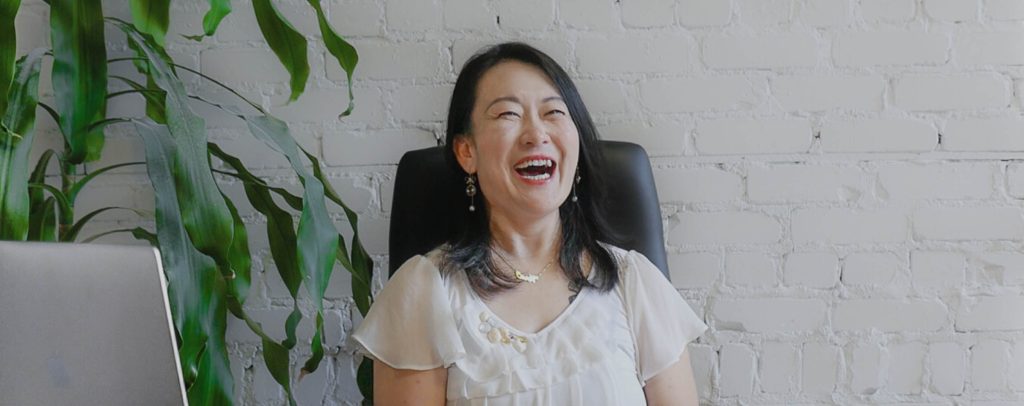 Laughing women sitting at a desk