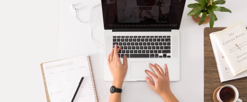 Aerial shot of someone writing on a laptop
