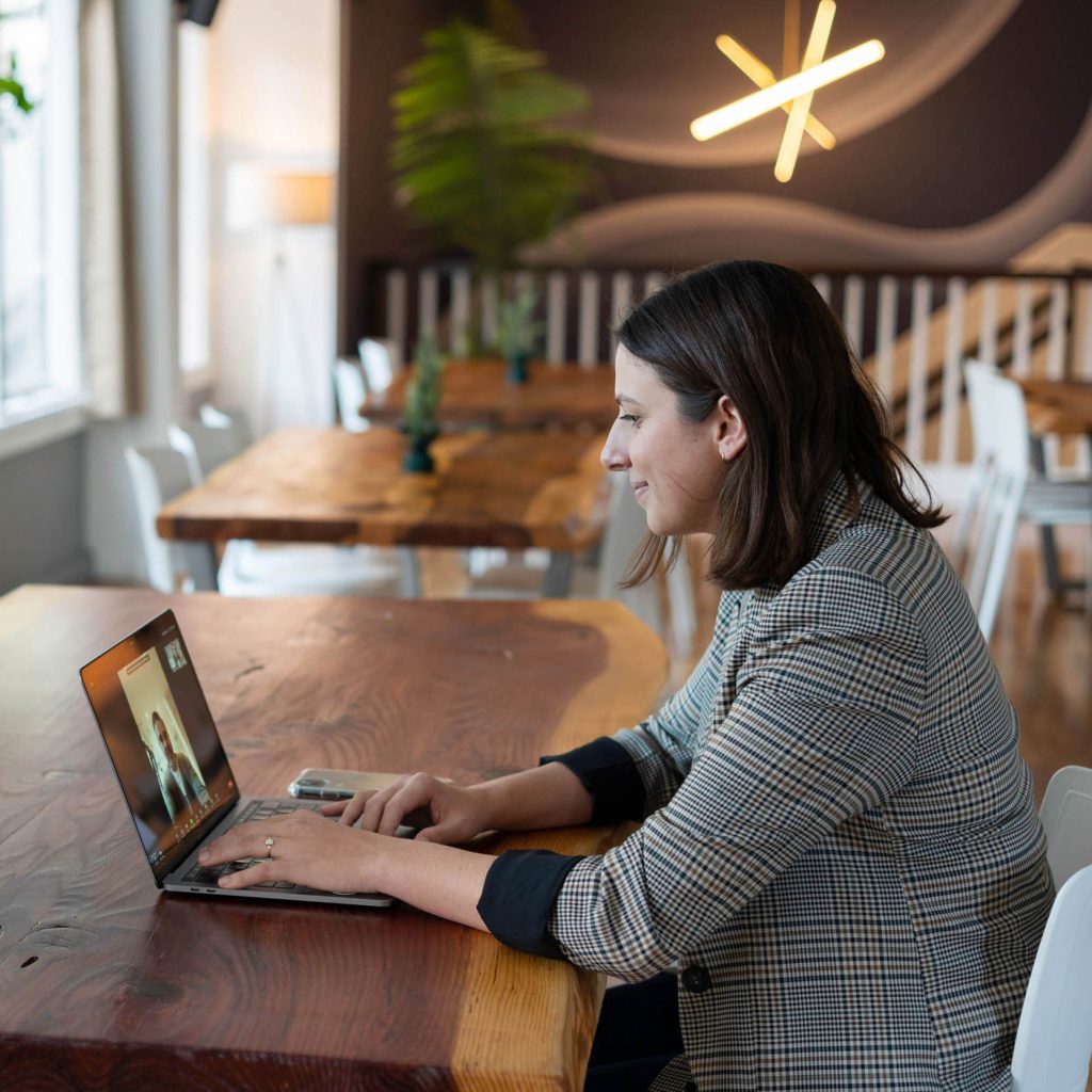 Smiling women on a virtual call in a cafe